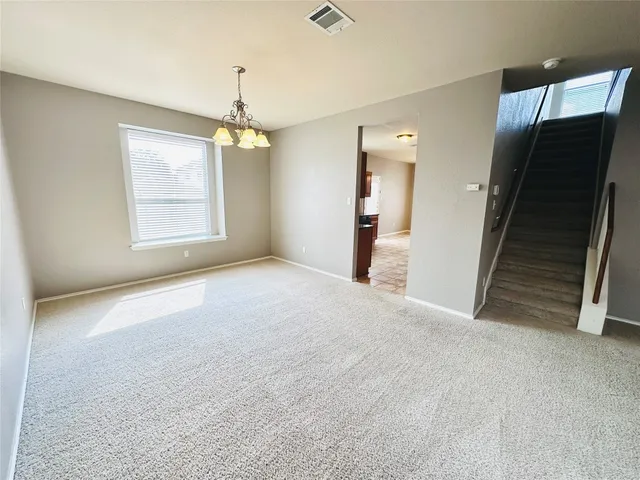 an empty room with windows and entryway