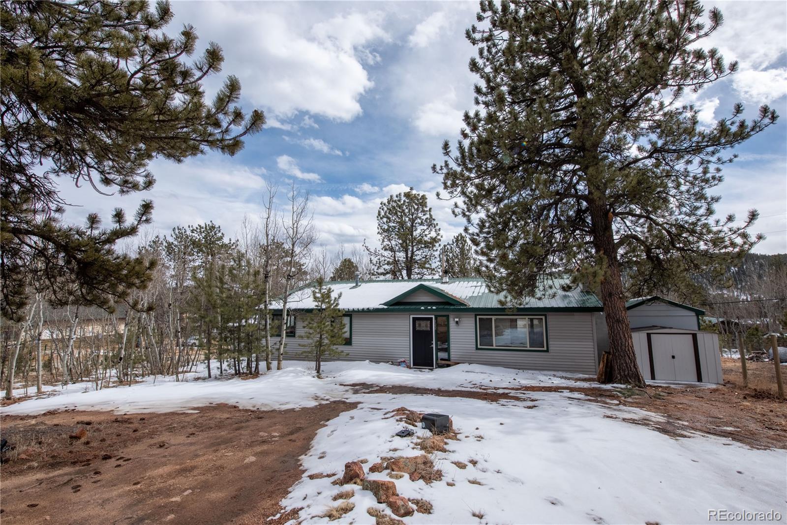 122 Neal Road Bailey, CO 80421 - Photo 3 of 25 a front view of a house with a yard