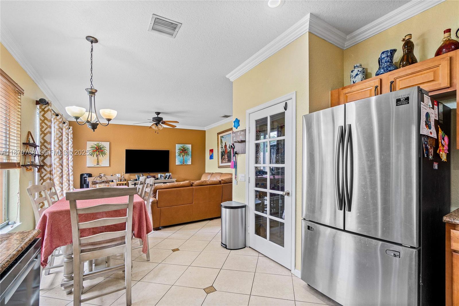 571 Calamint Point Royal Palm Beach, FL 33411 - Photo 15 of 51 a kitchen with stainless steel appliances a stove top oven and a refrigerator