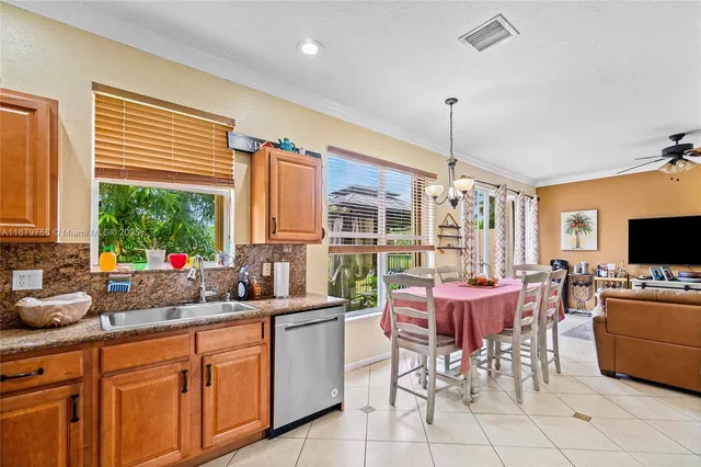 a kitchen with stainless steel appliances a sink and cabinets