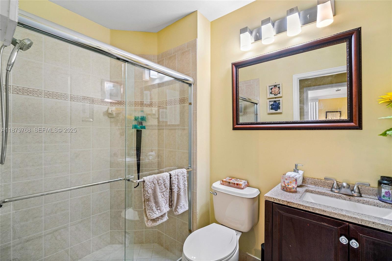 571 Calamint Point Royal Palm Beach, FL 33411 - Photo 18 of 51 a bathroom with a granite countertop sink mirror and toilet