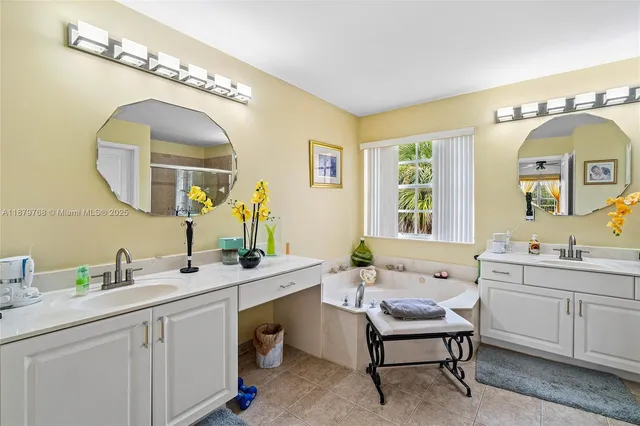 a bathroom with a double vanity sink and a mirror