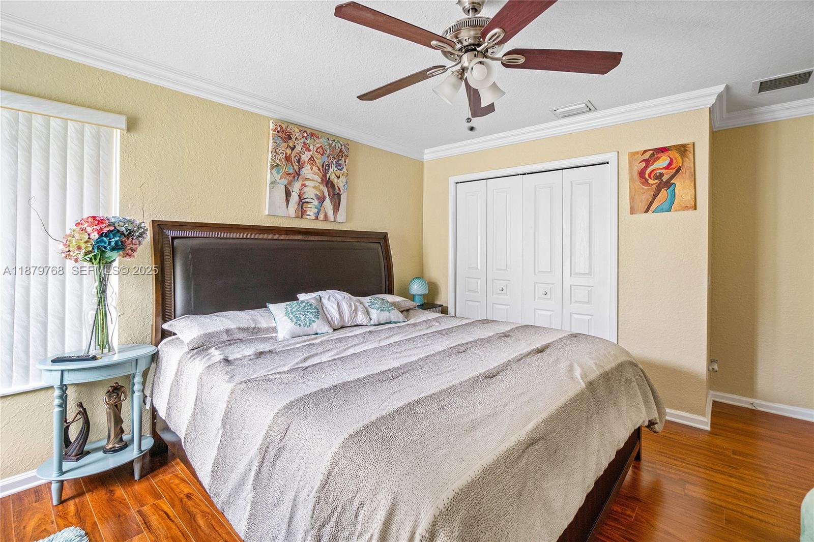 571 Calamint Point Royal Palm Beach, FL 33411 - Photo 22 of 51 a bedroom with bed and wooden floor