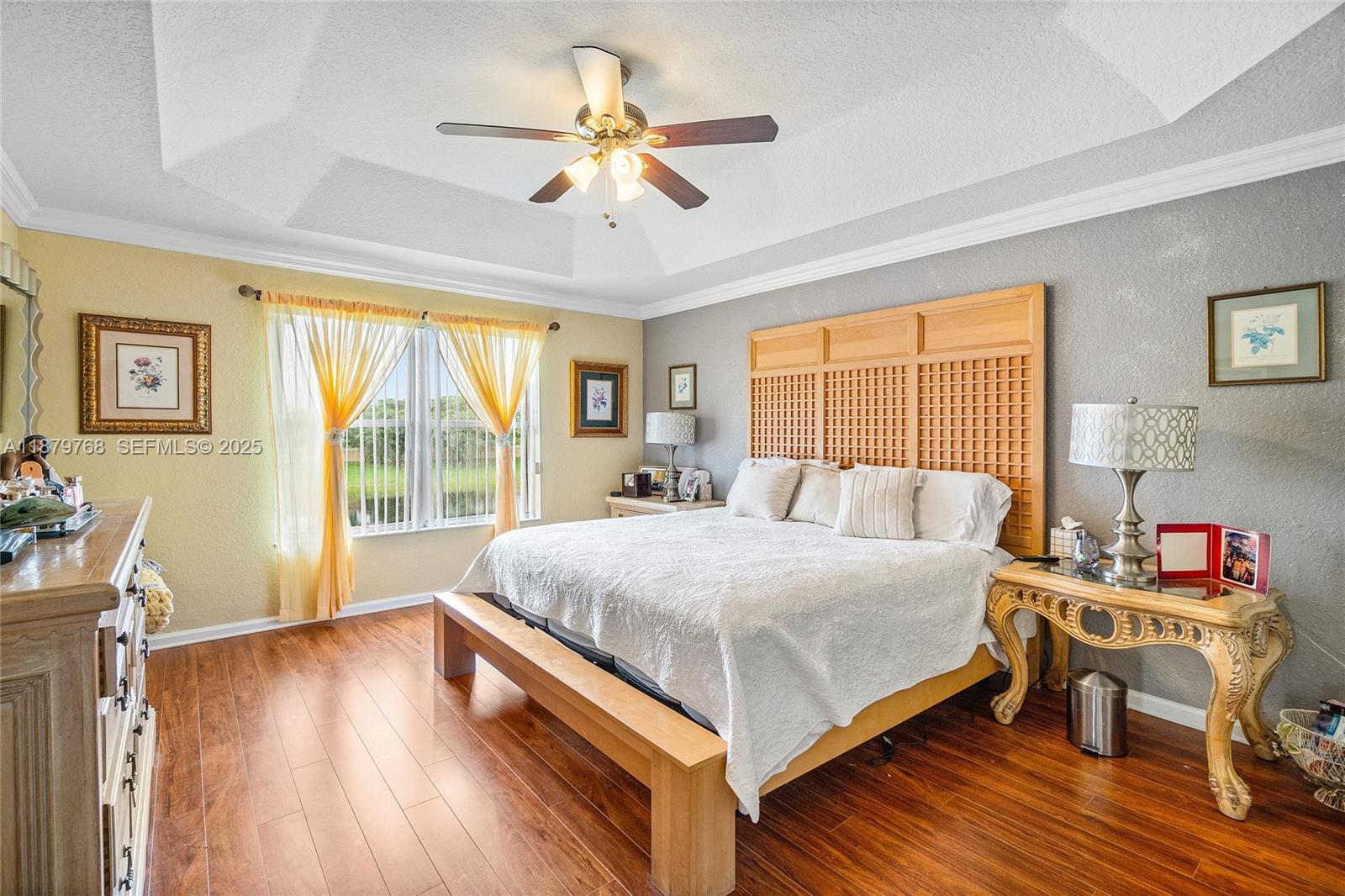 571 Calamint Point Royal Palm Beach, FL 33411 - Photo 23 of 51 a bedroom with a bed and a large window with wooden floor