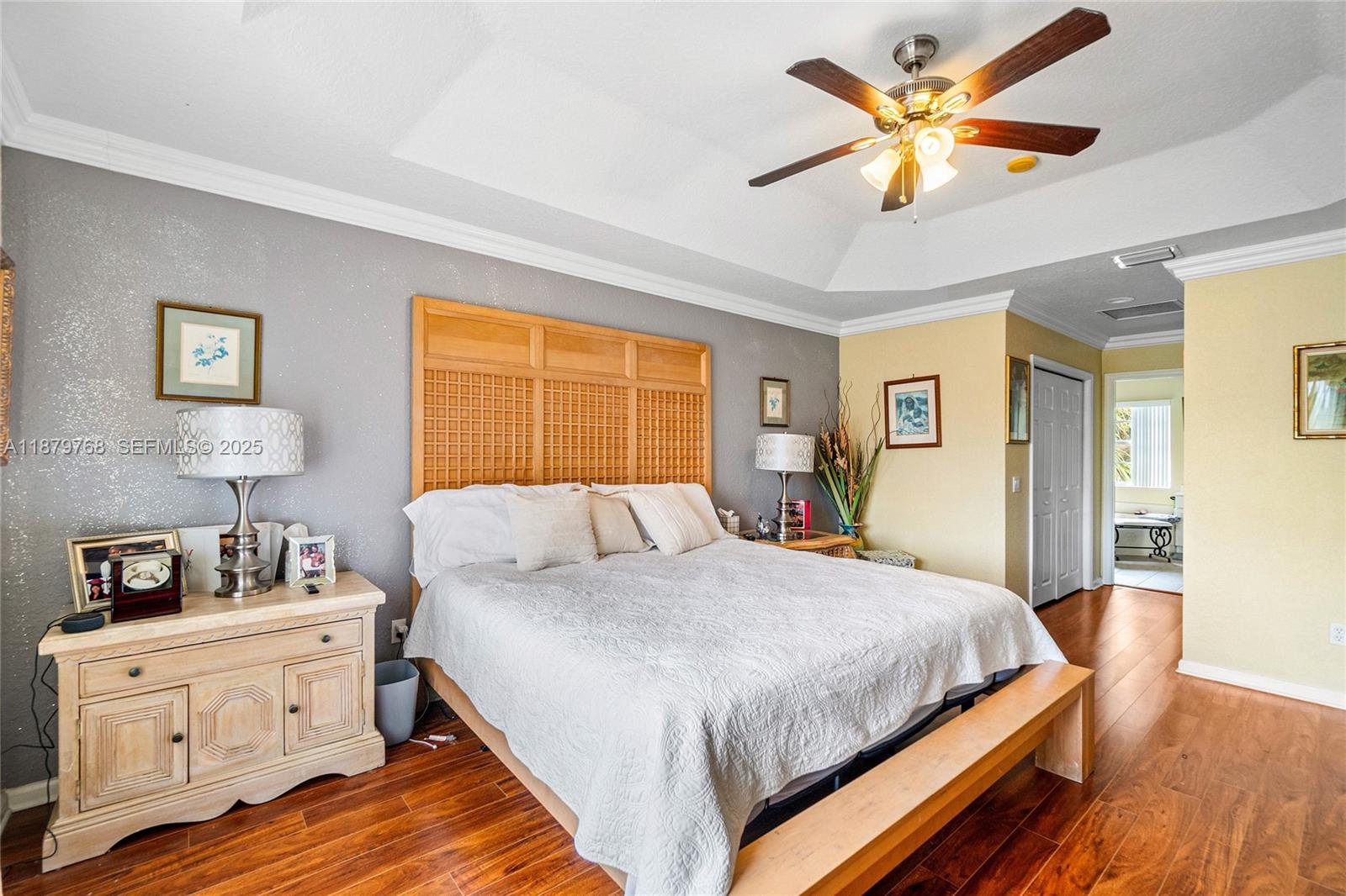 571 Calamint Point Royal Palm Beach, FL 33411 - Photo 25 of 51 a bedroom with a bed and wooden floor