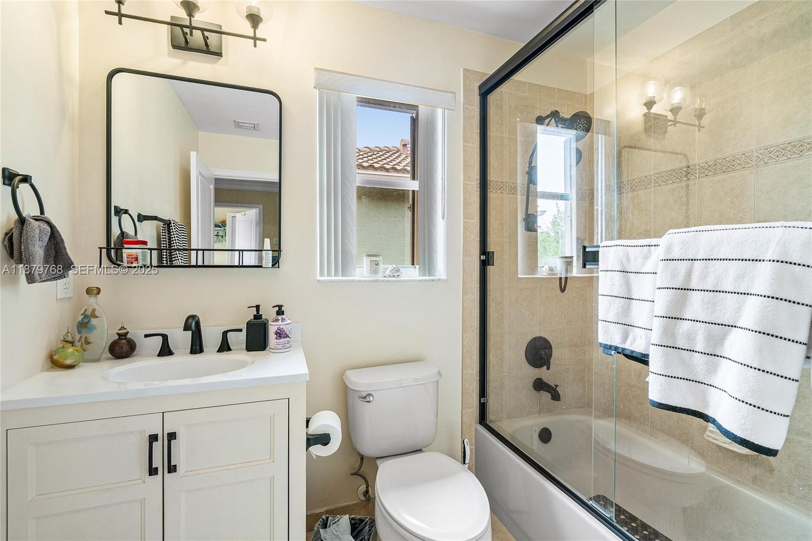 571 Calamint Point Royal Palm Beach, FL 33411 - Photo 28 of 51 a bathroom with a sink a toilet and shower