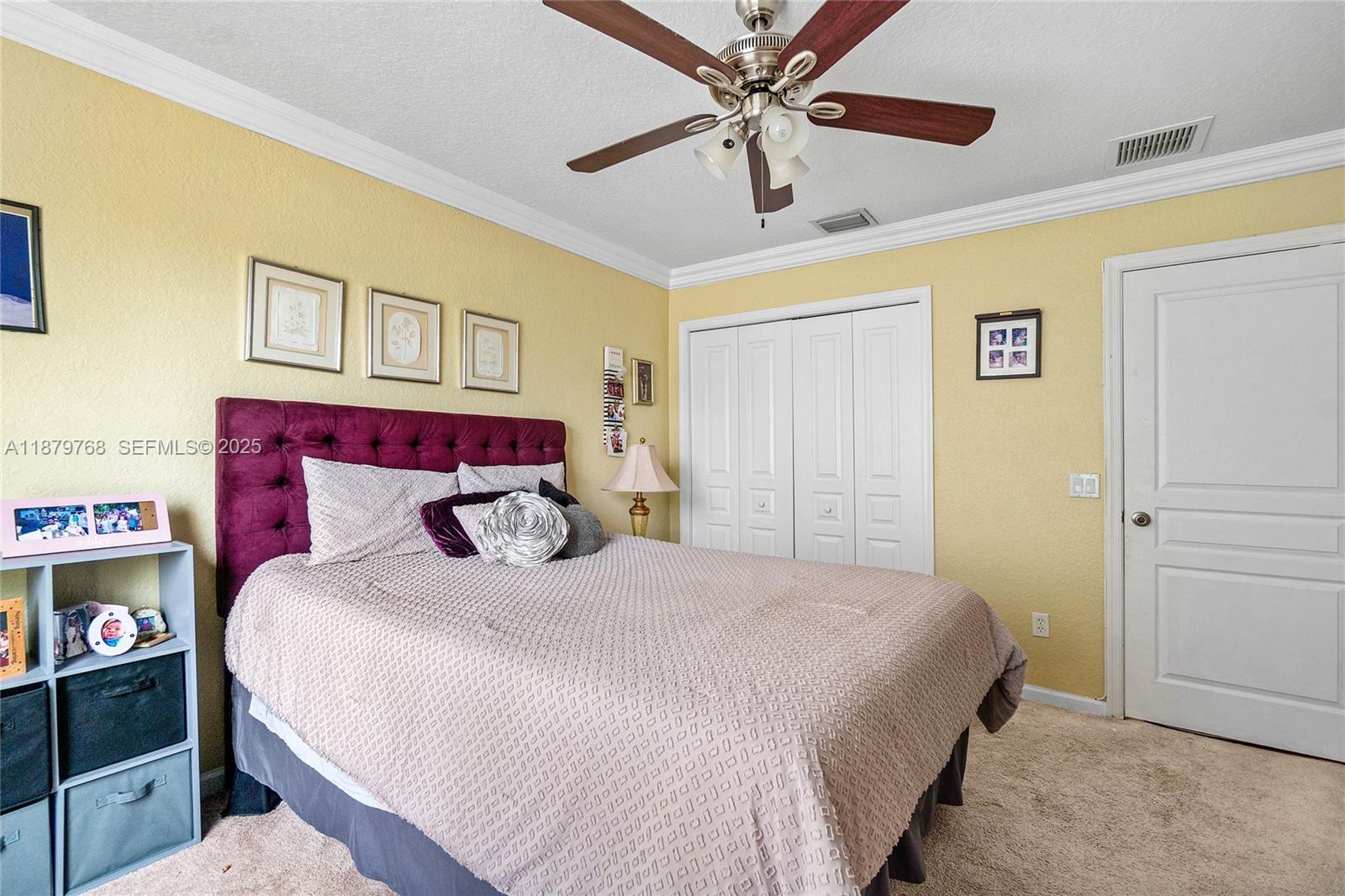 571 Calamint Point Royal Palm Beach, FL 33411 - Photo 30 of 51 a bedroom with a large bed and a chandelier