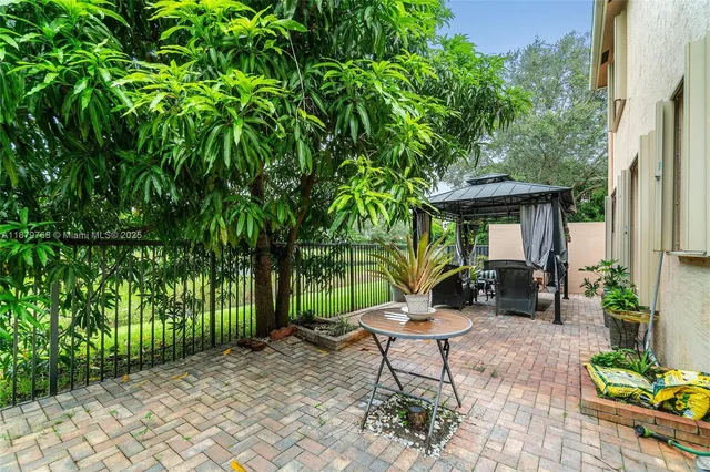 a view of a table and chairs in backyard of the house