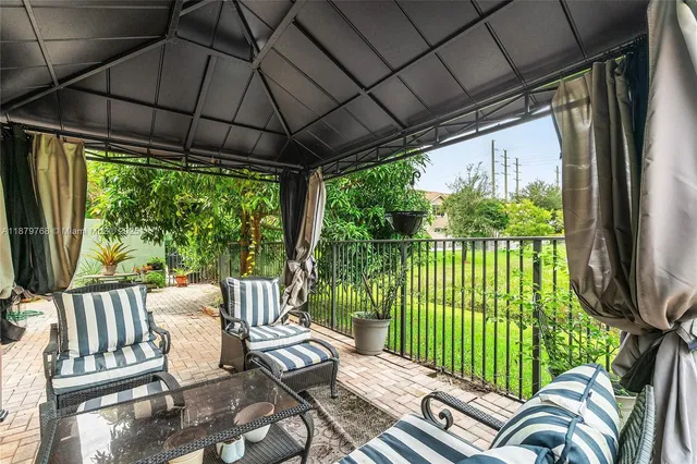 a patio with yard glass top table and chairs