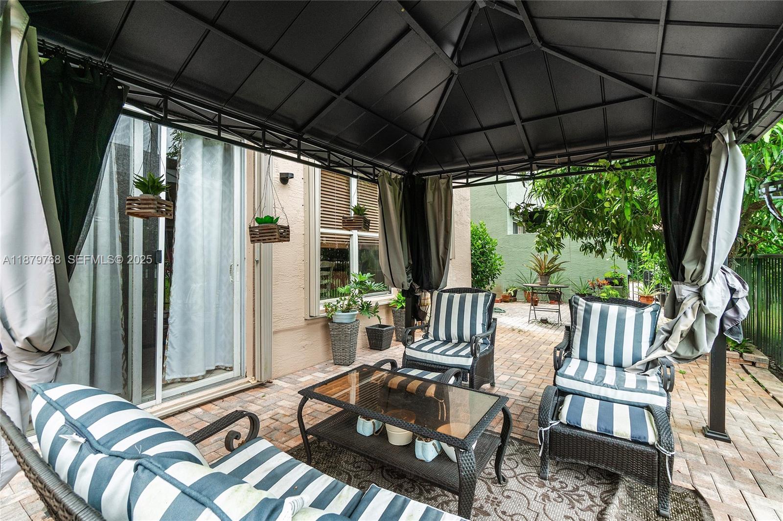 571 Calamint Point Royal Palm Beach, FL 33411 - Photo 35 of 51 a patio with yard glass top table and chairs