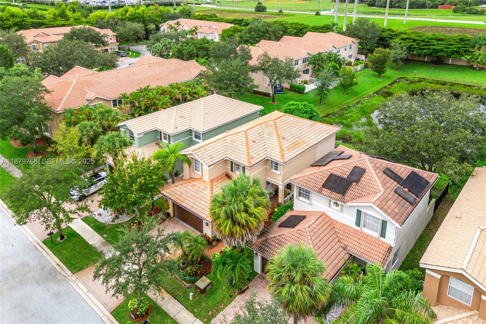 571 Calamint Point Royal Palm Beach, FL 33411 - Photo 37 of 51 an aerial view of a house with a garden