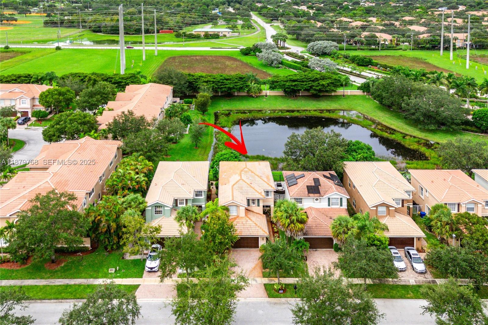 571 Calamint Point Royal Palm Beach, FL 33411 - Photo 39 of 51 an aerial view of a house with a garden and lake view