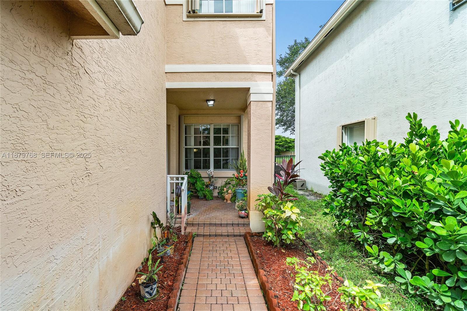 571 Calamint Point Royal Palm Beach, FL 33411 - Photo 4 of 51 a view of a pathway besides a house