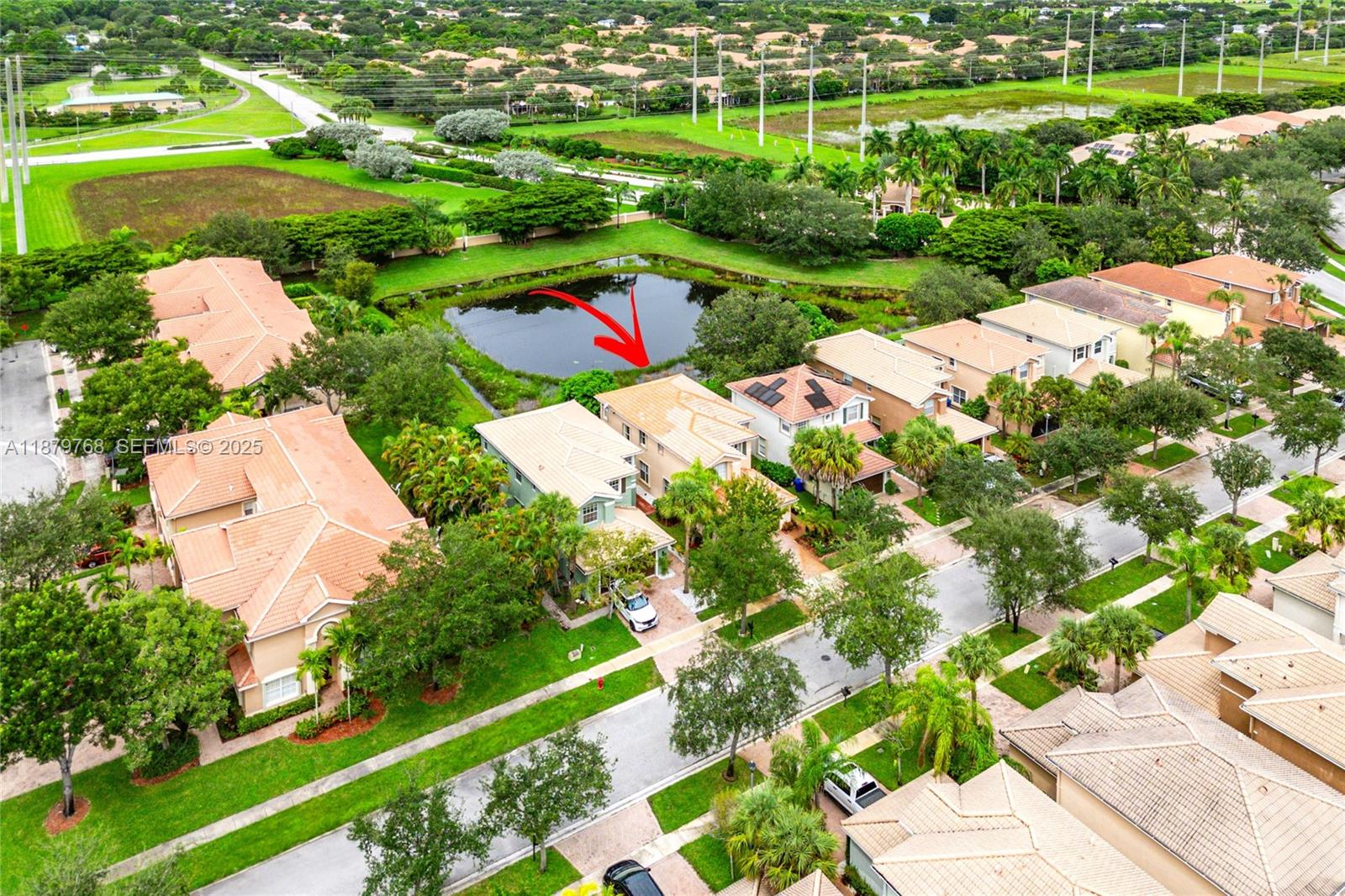 571 Calamint Point Royal Palm Beach, FL 33411 - Photo 41 of 51 a view of a lake with a yard