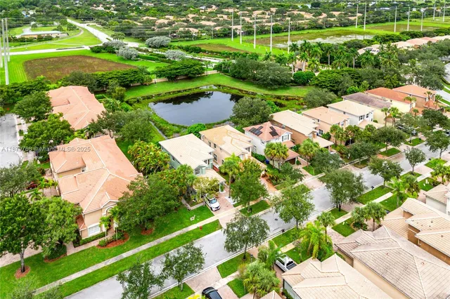 an aerial view of a house with a yard