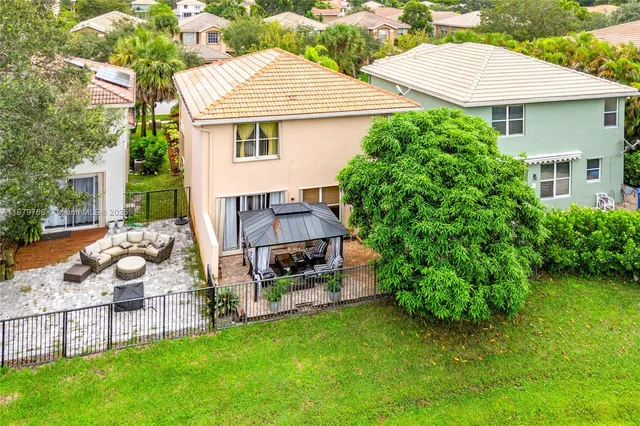 an aerial view of residential houses with outdoor space and street view