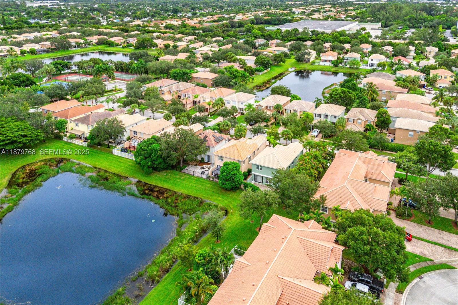 571 Calamint Point Royal Palm Beach, FL 33411 - Photo 49 of 51 an aerial view of a house with a garden and lake view