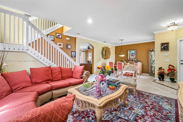 a living room with furniture a rug and a large window