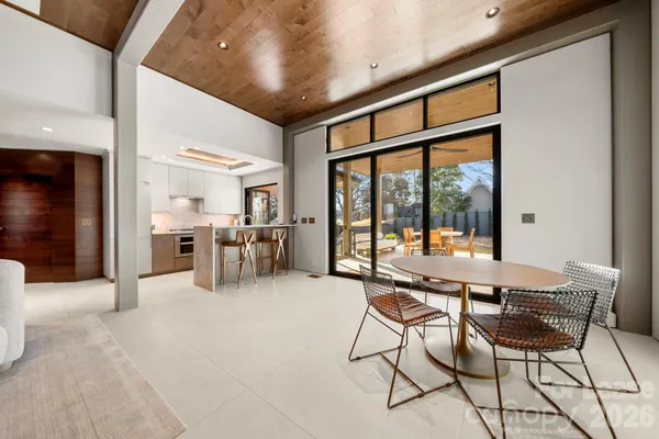 a view of a livingroom with furniture and floor to ceiling window
