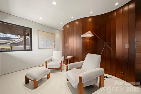 a living room with furniture and a painting