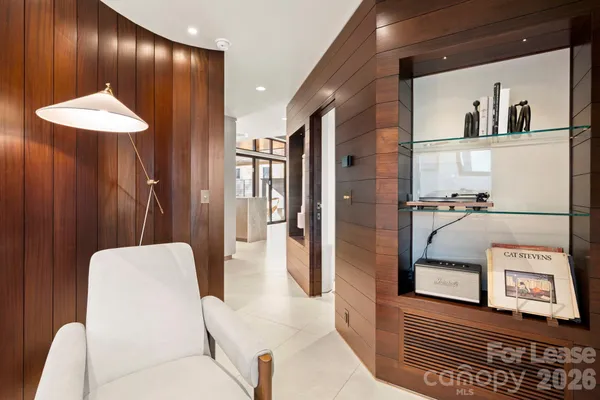 a living room with furniture and a walk in closet