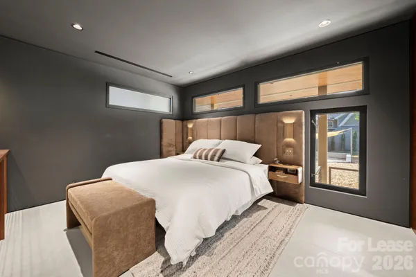 a bedroom with a large bed and a large window