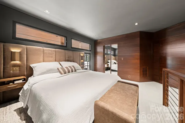 a bed room with a bed and a large window