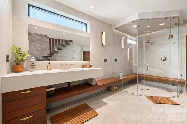 a bathroom with a tub a sink and mirror