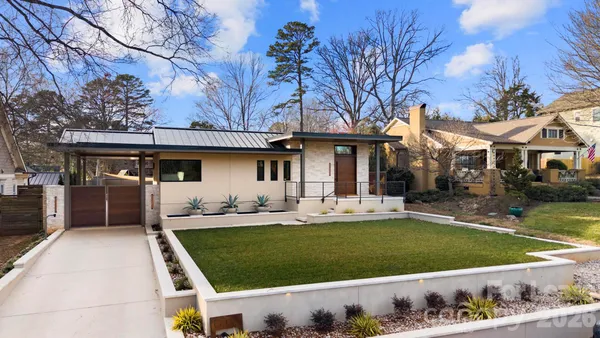 a front view of a house with a garden and patio