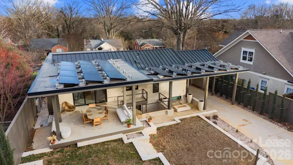 a view of roof deck with table and chairs wooden floor and fence