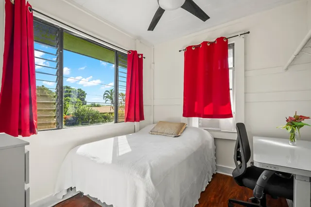 a bed sitting in a bedroom next to a window