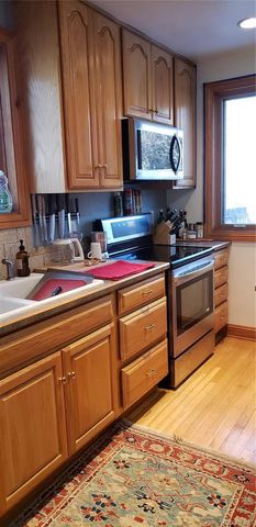 a kitchen with stainless steel appliances granite countertop a sink and a stove