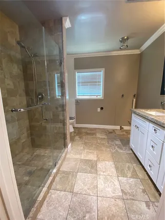 a bathroom with a glass door shower