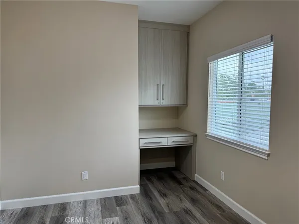 a view of room with window and wooden floor