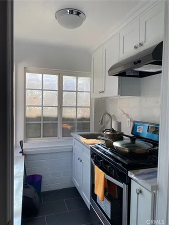 a kitchen with stainless steel appliances a stove and a microwave