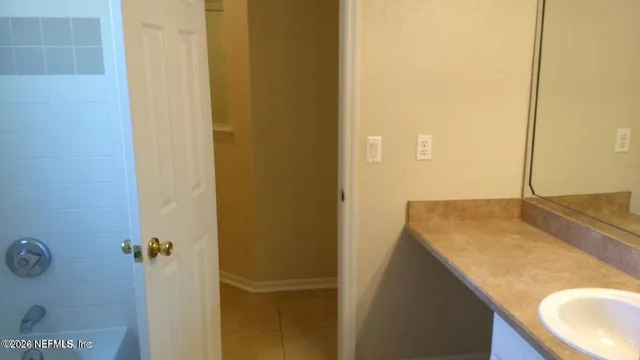 a white toilet sitting next to a bath tub