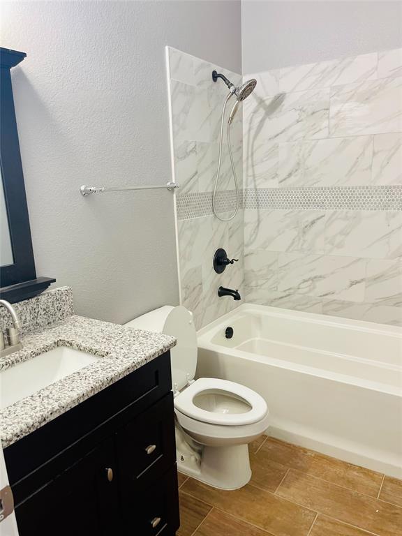 548 Kerry Street Crowley, TX 76036 - Photo 24 of 35 a bathroom with a granite countertop bathtub shower sink vanity and toilet
