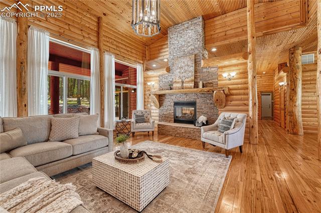 15975 Winding Trail Road Colorado Springs, CO 80908 - Photo 11 of 50 Large gas log, pass-through fireplace accented by stacked stone and log mantle