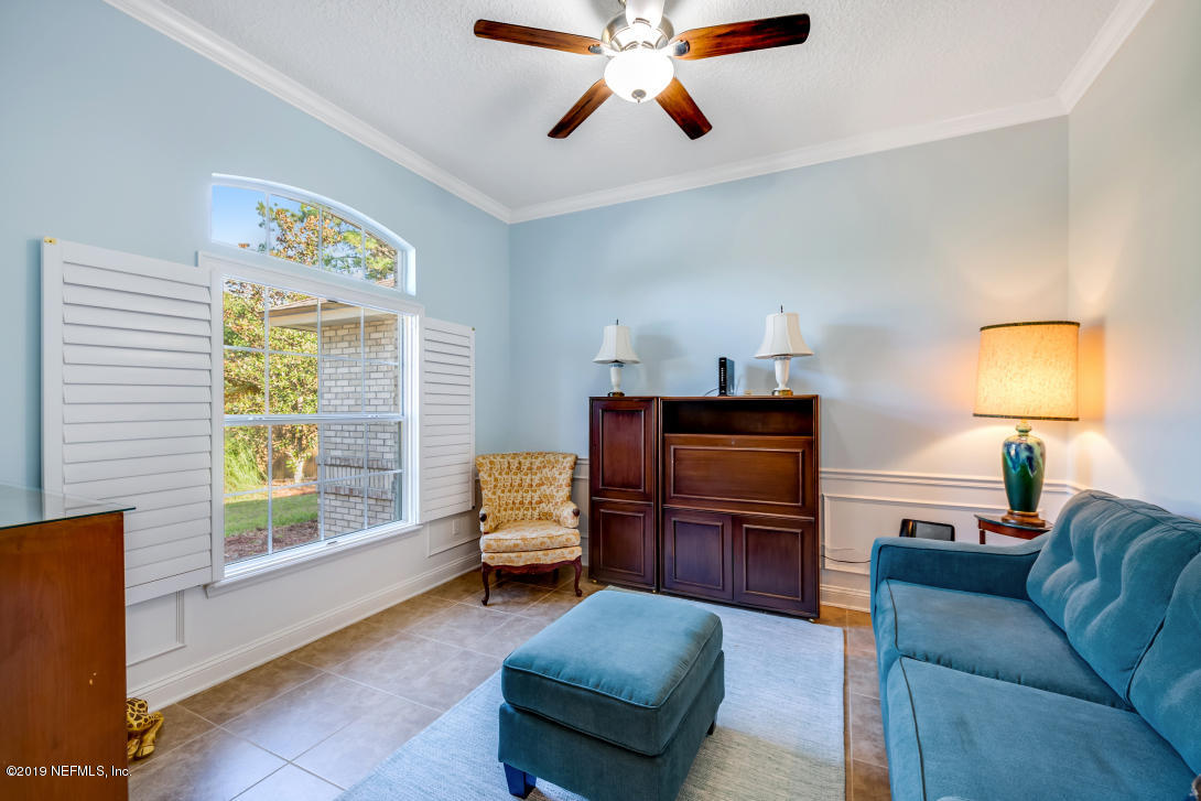87465 Creekside Drive Yulee, FL 32097 - Photo 13 of 40 a living room with furniture and a flat screen tv