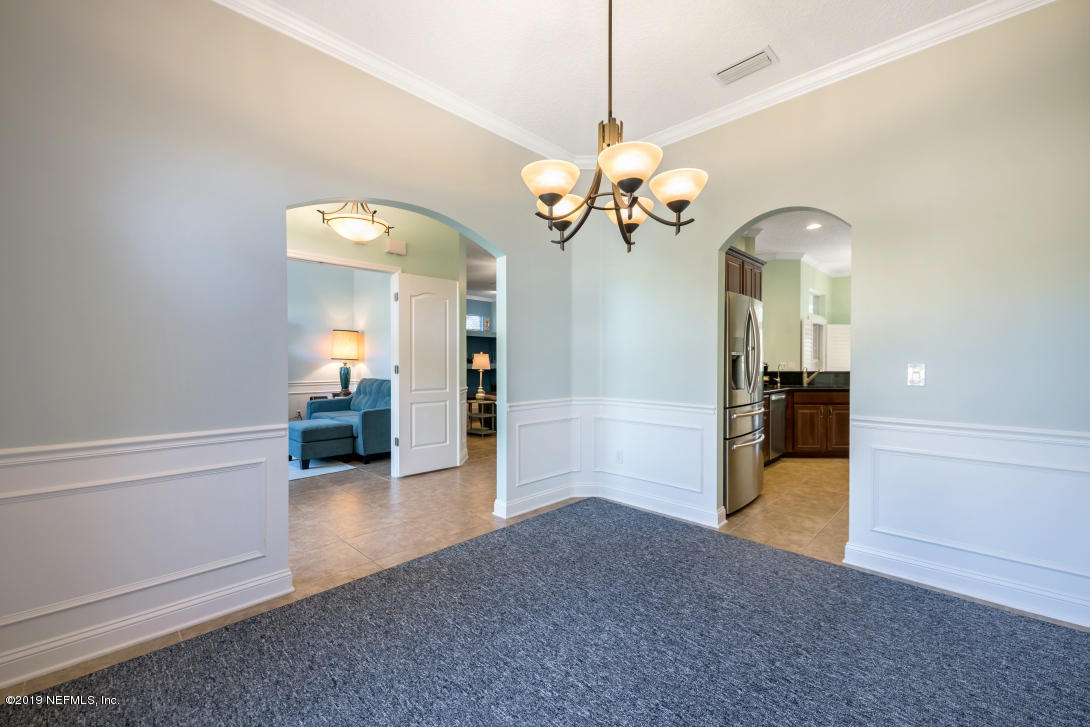 87465 Creekside Drive Yulee, FL 32097 - Photo 14 of 40 wooden floor in an empty room with a window