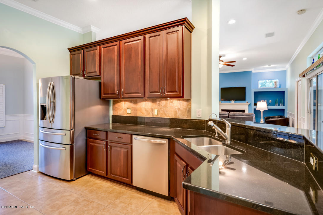 87465 Creekside Drive Yulee, FL 32097 - Photo 19 of 40 a kitchen with a refrigerator stove and sink