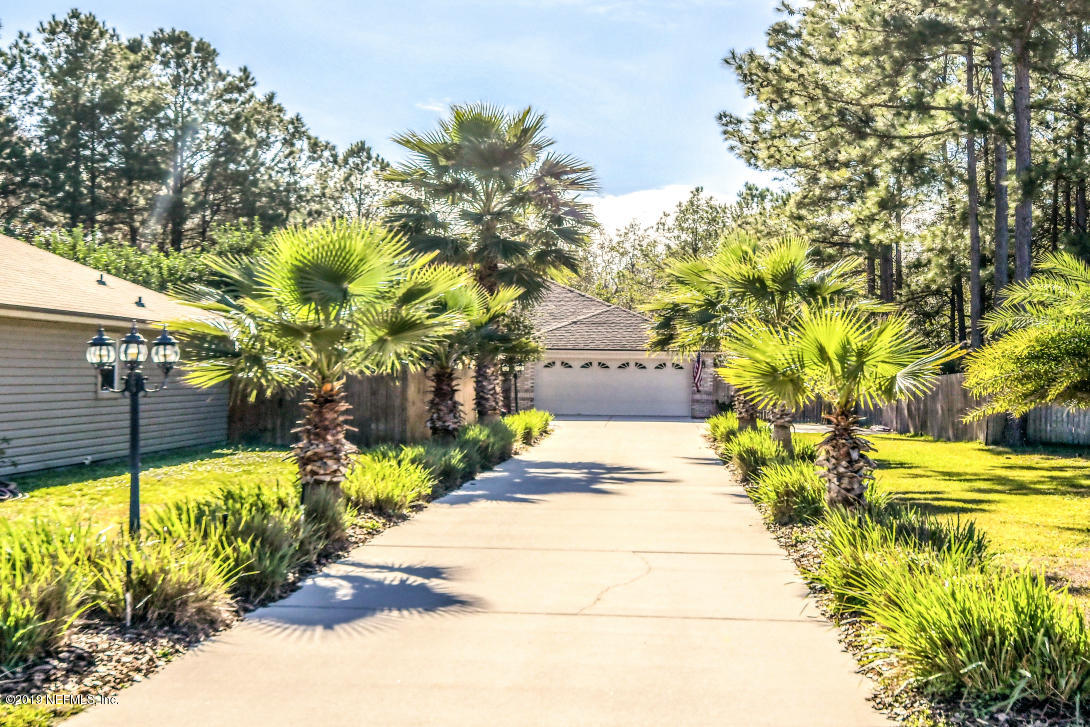 87465 Creekside Drive Yulee, FL 32097 - Photo 2 of 40 a view of a backyard of the house