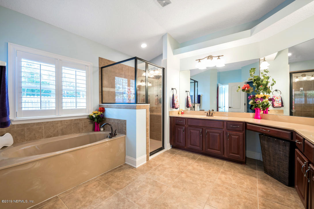 87465 Creekside Drive Yulee, FL 32097 - Photo 24 of 40 a spacious bathroom with a tub sink shower and mirror