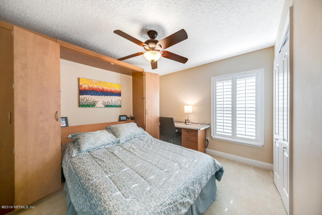 87465 Creekside Drive Yulee, FL 32097 - Photo 30 of 40 a bedroom with a bed and a large window
