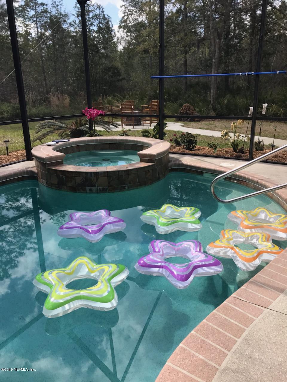 87465 Creekside Drive Yulee, FL 32097 - Photo 3 of 40 a view of a swimming pool with a yard