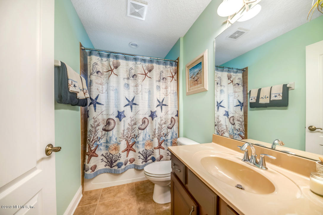 87465 Creekside Drive Yulee, FL 32097 - Photo 31 of 40 a bathroom with a sink a toilet and shower curtain