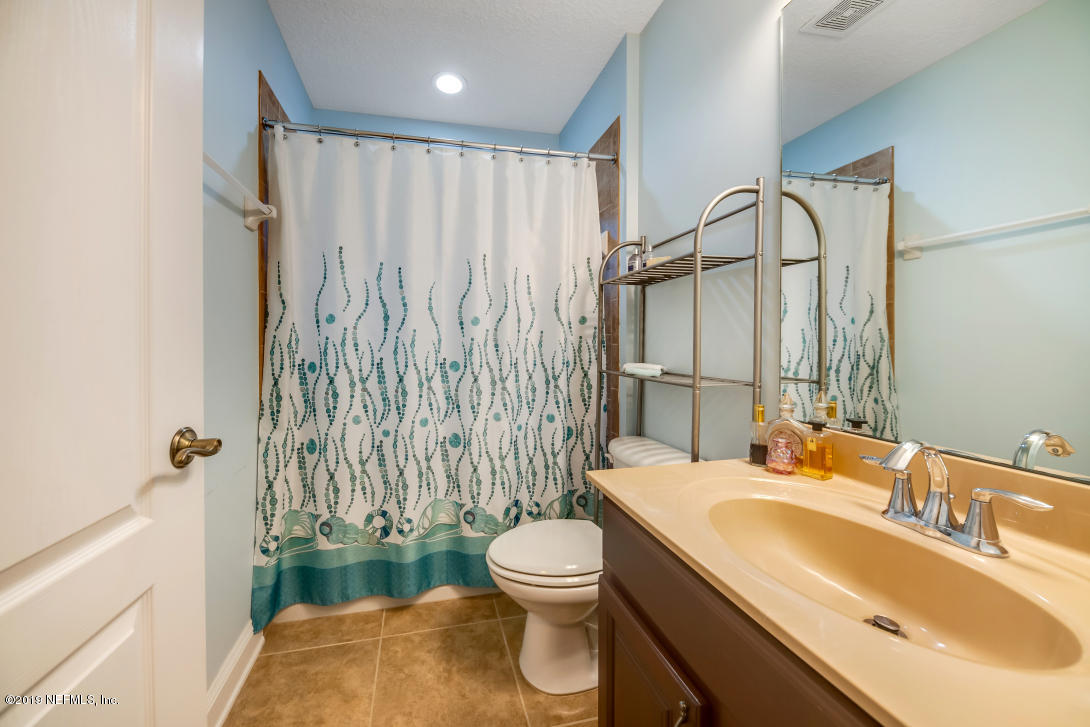 87465 Creekside Drive Yulee, FL 32097 - Photo 32 of 40 a bathroom with a granite countertop sink toilet and shower