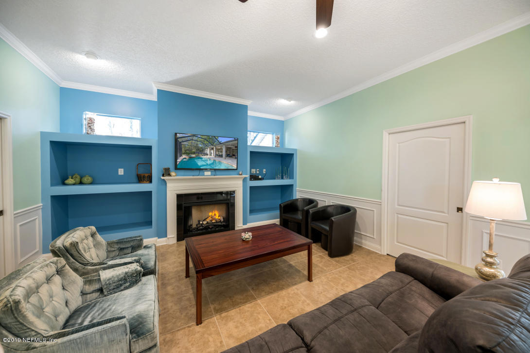 87465 Creekside Drive Yulee, FL 32097 - Photo 34 of 40 a living room with furniture and a fireplace