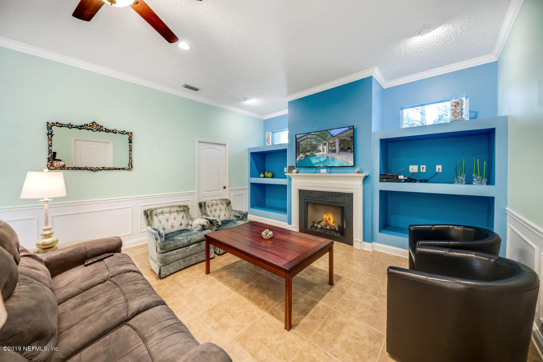 87465 Creekside Drive Yulee, FL 32097 - Photo 35 of 40 a living room with furniture and a fireplace