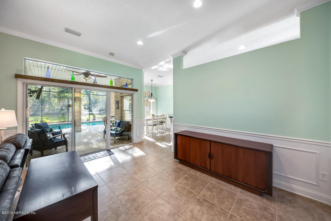 87465 Creekside Drive Yulee, FL 32097 - Photo 38 of 40 a room with furniture and large windows